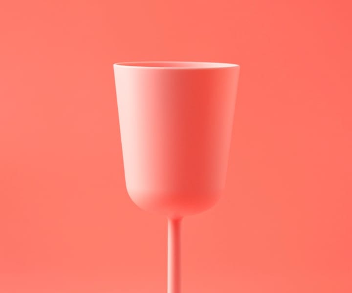 This is a cup of juice with a pink background-color